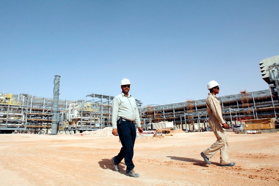 Workers seen at a construction site during a press tour in the desert at Khurais oil field, about 160 km from Riyadh, Saudi Arabia, 23 June 2008. A top executive at Saudi Aramco said that the company's plans are on track for its Khurais project south of Riyadh which puts put 1.2 million barrels per day (bpd), Gulf Daily News reported. Ali Heider, EPA-EFE/File