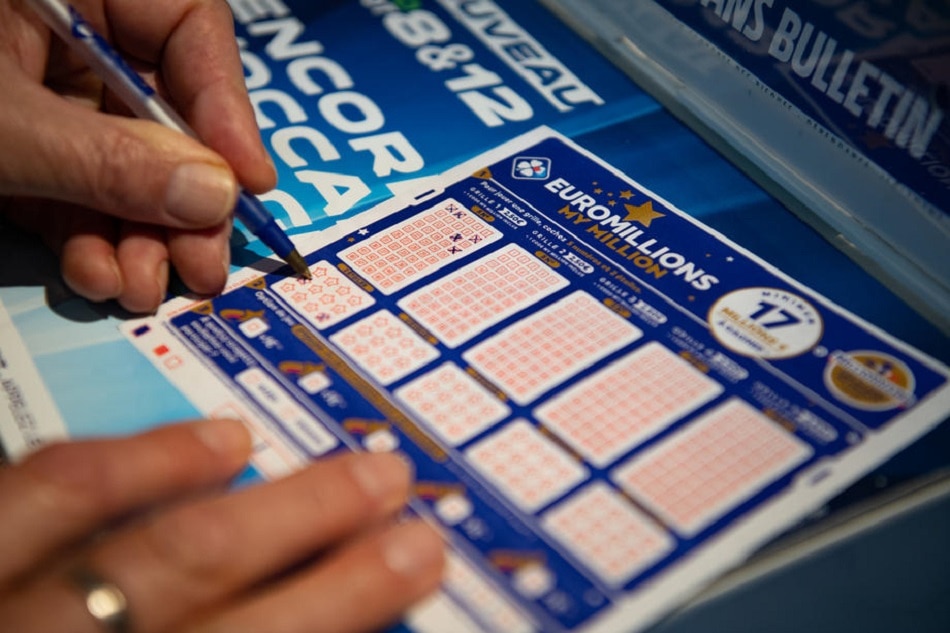 A person plays a EuroMillions grid in Bordeaux, France, on December 4, 2020. Caroline Blumberg, EPA-EFE