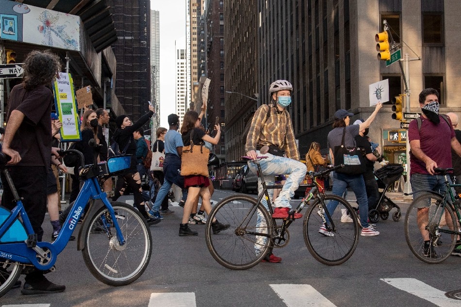 People use their bikes to block the street for protesters against Fox News, claiming their ideologies teach white supremacy that leads to hate crimes, such as the recent mass shooting at a supermarket in a predominately black neighborhood in Buffalo, New York, in New York, New York, USA, 18 May 2022. Sarah Yenesel, EPA-EFE.