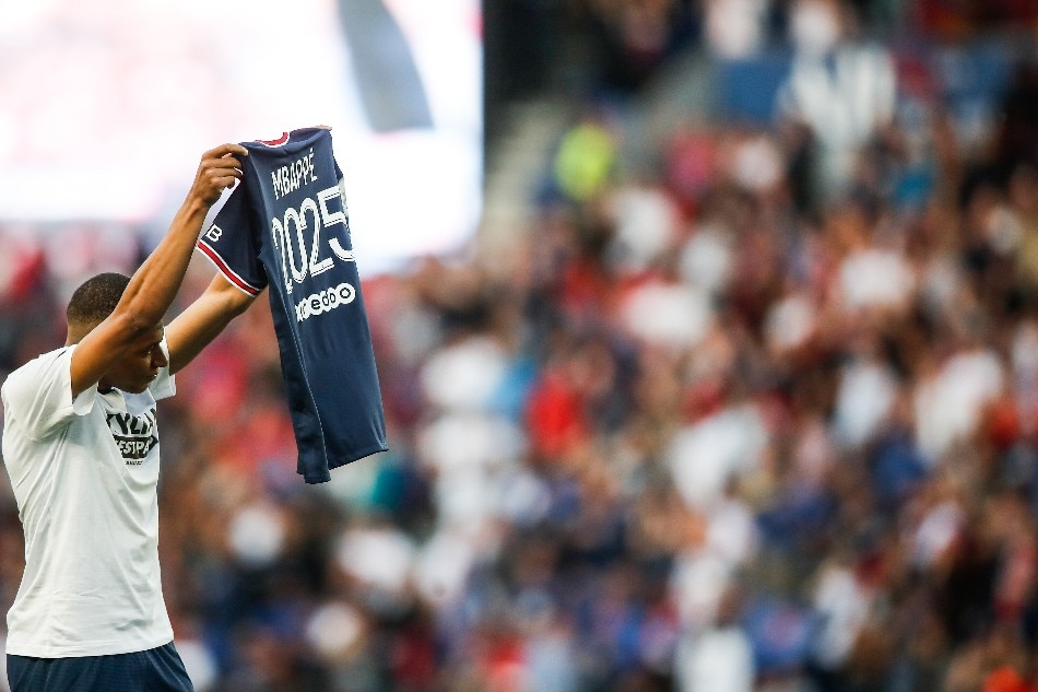 Paris Saint Germain's Kylian Mbappe holds a special jersey to announce the signing of new contract with PSG until 30 June 2025, before the French Ligue 1 soccer match Paris Saint Germain vs FC Metz at the Parc des Princes stadium in Paris, France, 21 May 2022. Mohammed Badra, EPA-EFE