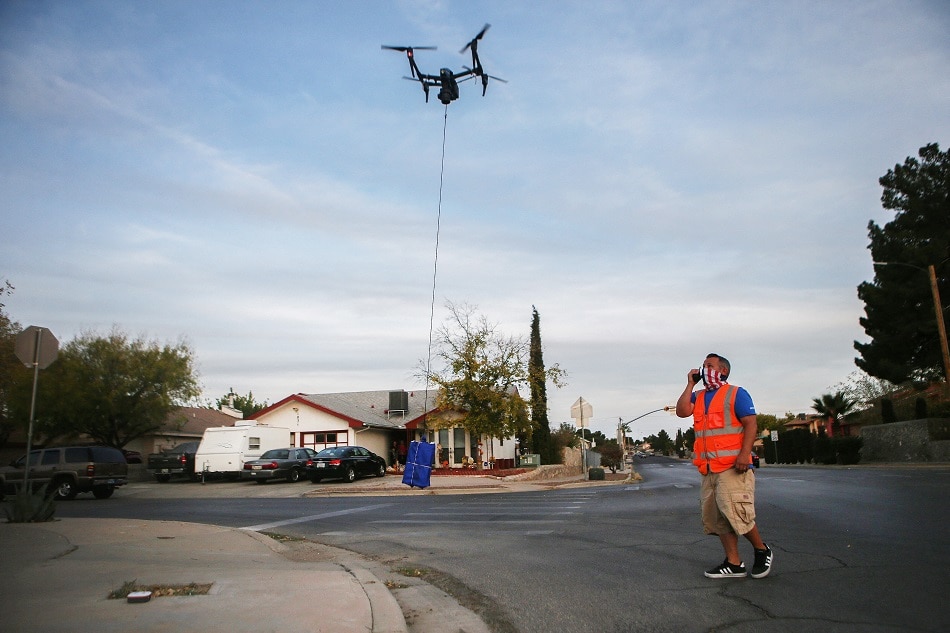 DroneUp pilot Chris Holmes visually observes for safety a drone arriving to deliver a COVID-19 self-collection test kit to a home, after being ordered from Walmart by a resident, amid a Covid-19 surge in El Paso on November 20, 2020 in El Paso, Texas. Mario Tama, Getty Images North America vi AFP 