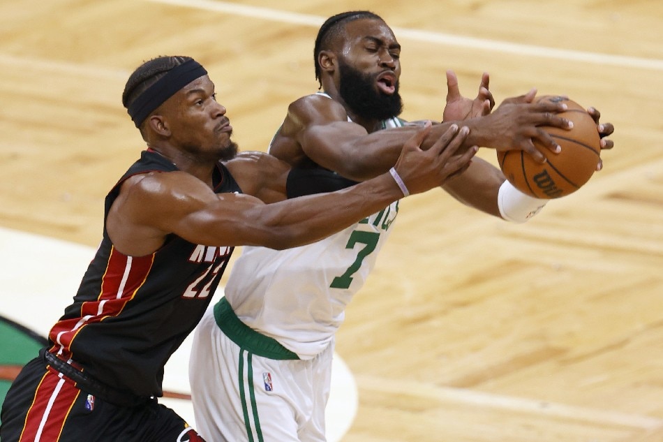 Boston Celtics guard Jaylen Brown (R), and Miami Heat forward Jimmy Butler (L) reach for a loose ball, during the first half of Game 4 of the NBA Eastern Conference Finals between the Boston Celtics and the Miami Heat at TD Garden in Boston, Massachusetts, USA, 23 May 2022. CJ Gunther, EPA-EFE.