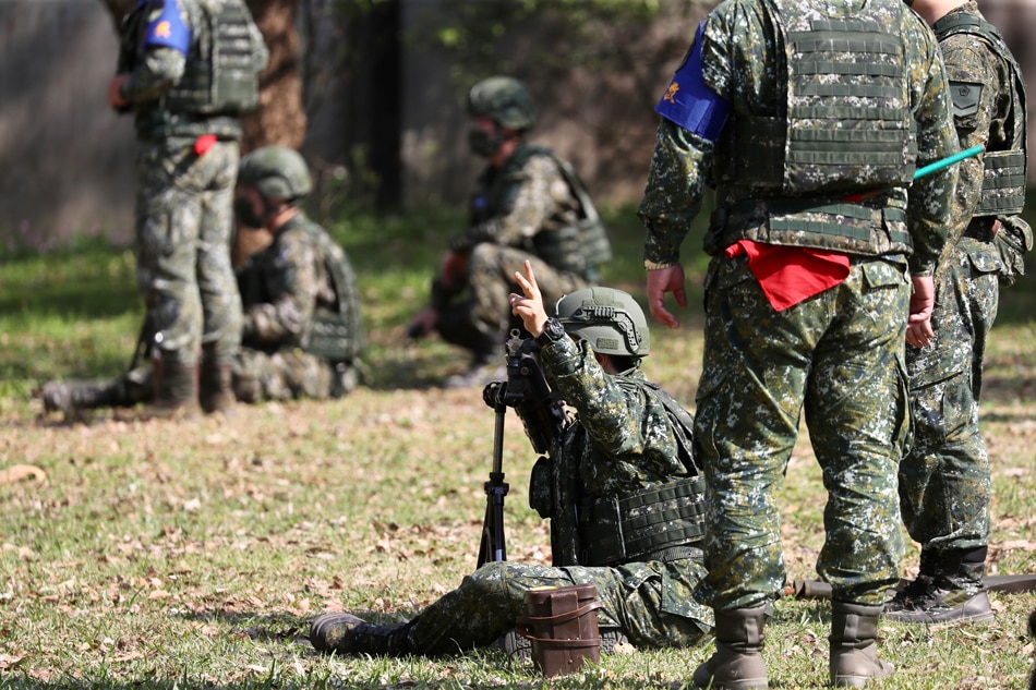 Taiwanese military personnel practice with a mortar during the visit of President Tsai Ing-wen at a military camp in New Taipei city, Taiwan, on March 12, 2022. Ritchie B. Tongo, EPA-EFE/file