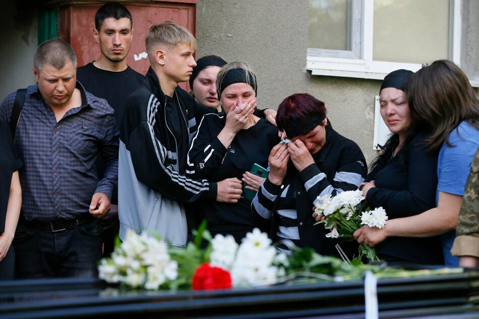  Relatives and friends attend a funeral ceremony of Ukrainian serviceman who was killed in action, in the small city of Rozdilna of Odesa region, Ukraine, May 22, 2022. On Feb. 24, Russian troops entered Ukrainian territory starting a conflict that has provoked destruction and a humanitarian crisis. Stepan Franko, EPA-EFE 