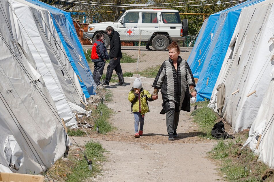 Civilians who were evacuated from Azovstal, walk in the temporary accommodation center in Bezimenoye village near Mariupol, Ukraine, on May 7, 2022. Alessandro Guerra, EPA-EFE/file