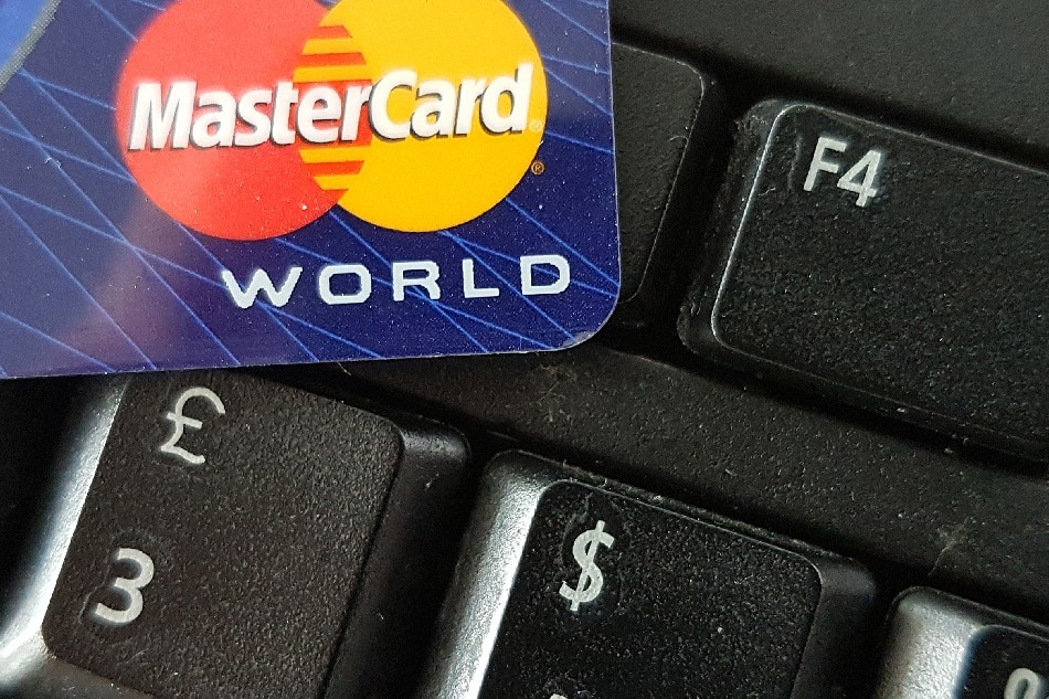 A close-up image showing a Mastercard credit card on a computer keyboard in Frankfurt, Germany, Sept. 10, 2016. Mauritz Antin, EPA-EFE/File