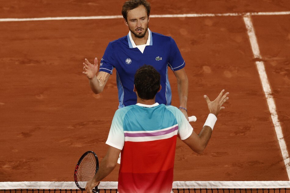Daniil Medvedev of Russia shakes hands after loosing his match against Marin Cilic of Croatia in their men’s fourth round match during the French Open tennis tournament at Roland Garros in Paris, France, 30 May 2022. Yoan Valat, EPA-EFE