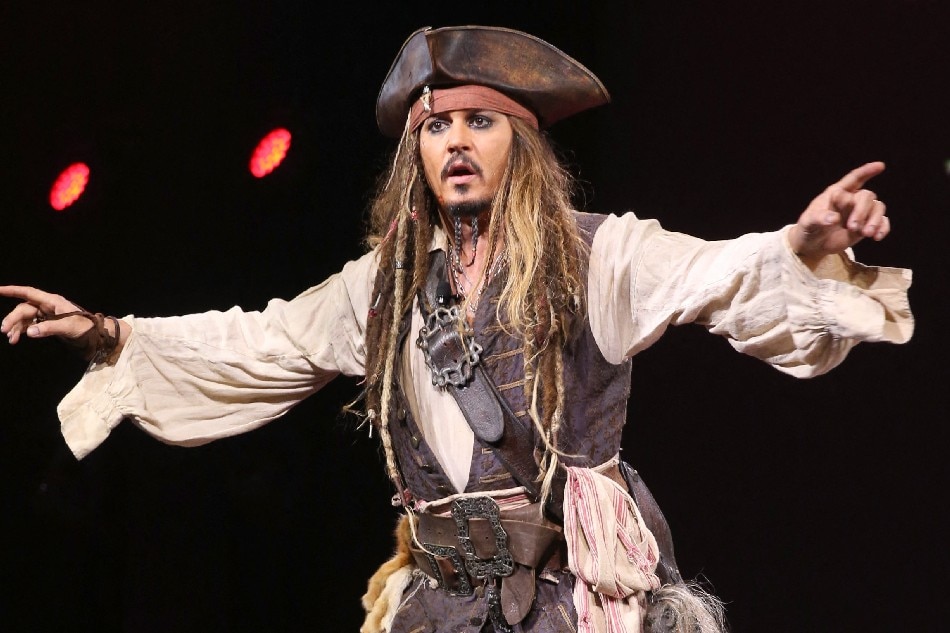 Actor Johnny Depp, dressed as Captain Jack Sparrow, of PIRATES OF THE CARIBBEAN: DEAD MEN TELL NO TALES took part today in 'Worlds, Galaxies, and Universes: Live Action at The Walt Disney Studios' presentation at Disney's D23 EXPO 2015 in Anaheim, Calif. Jesse Grant/Getty Images for Disney/AFP