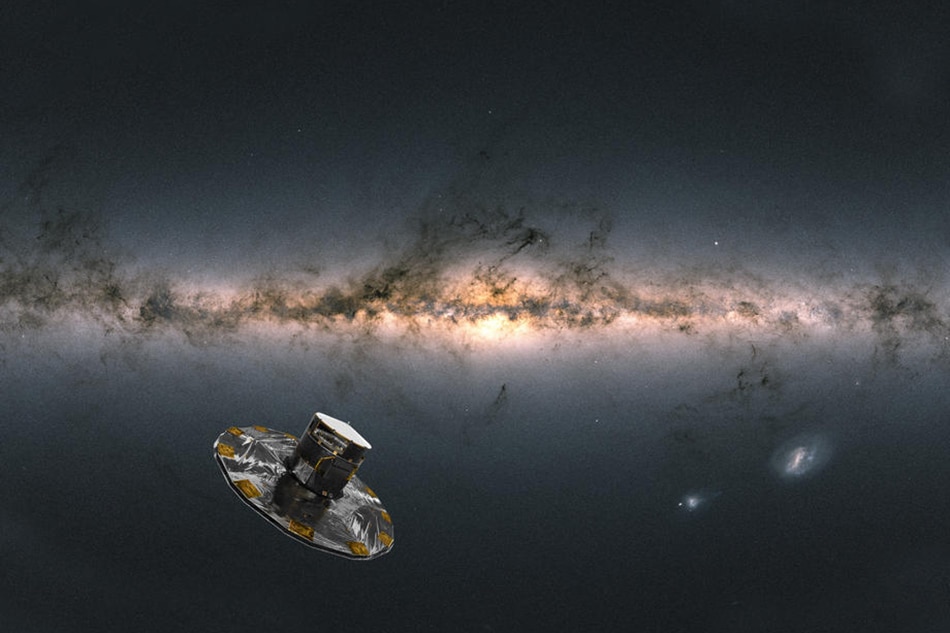 A handout photo made available June 13, 2022 by European Space Agency showing an artist impression of ESA's Gaia satellite observing the Milky Way. EPA-EFE/Handout