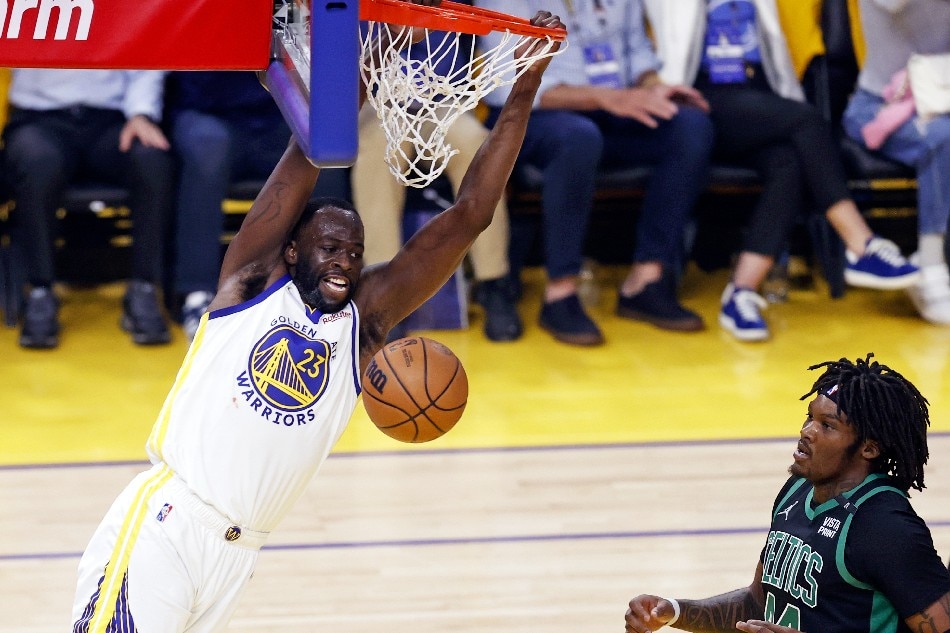 Golden State Warriors forward Draymond Green (L) dunks the ball past a defending Boston Celtics center Robert Williams III (R) during the first half of Game 5 of the NBA Finals at the Chase Center in San Francisco, California, USA, 13 June 2022. John Mabanglo, EPA-EFE