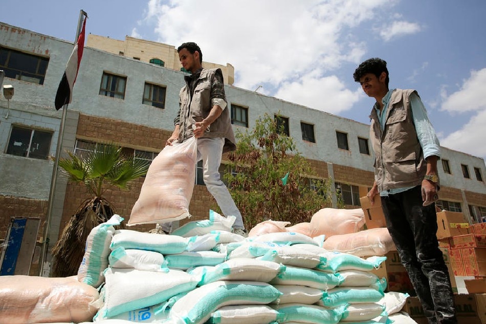 Aid workers unload a truck with emergency food rations for war-affected people amid a food insecurity, in Sana'a, Yemen, 26 April 2022 (issued 28 April 2022). Yemen is currently experiencing a food insecurity due to the prolonged conflict and the resultant economic crisis as well as the impact of the Russian invasion of Ukraine as the war-ravaged Arab country imports almost 90 percent of its overall food supply, including over 30 percent of wheat imports coming from Ukraine and at least eight percent from Russia.  YAHYA ARHAB, EPA-EFE