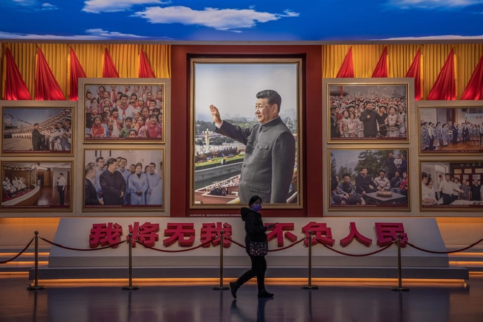 A visitors walks in front of pictures showing Chinese President Xi Jinping at the Museum of the Communist Party of China, in Beijing, November 23, 2021. Roman Pilipey, EPA-EFE