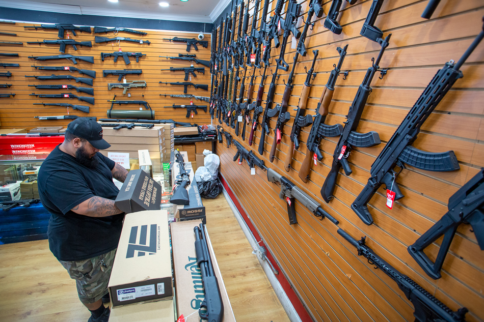 A worker at the Miami Guns Store and Range checks a semi-automatic gun, in Hialeah, Florida, USA, June 22, 2022. On June 21, a group of US senators released the Bipartisan Safer Communities Act to control gun violence, which if passed by Congress, could become the most significant renovation of the nation