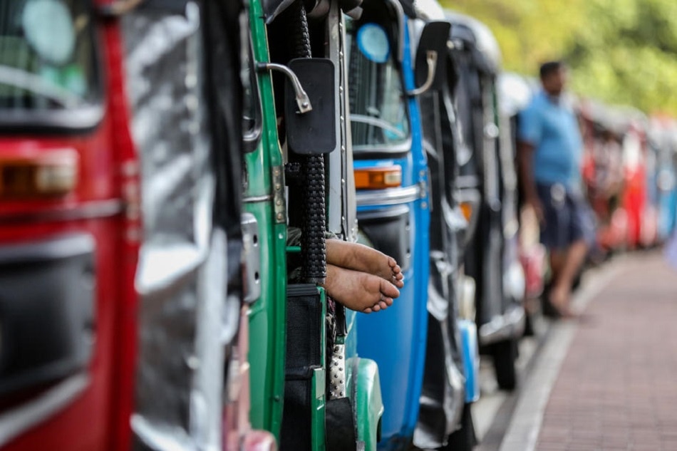 Auto-rickshaw drivers wait in a queue to get fuel from a gas station amid a fuel shortage in Colombo, Sri Lanka, June 27, 2022. Chamila Karunarathne, EPA-EFE