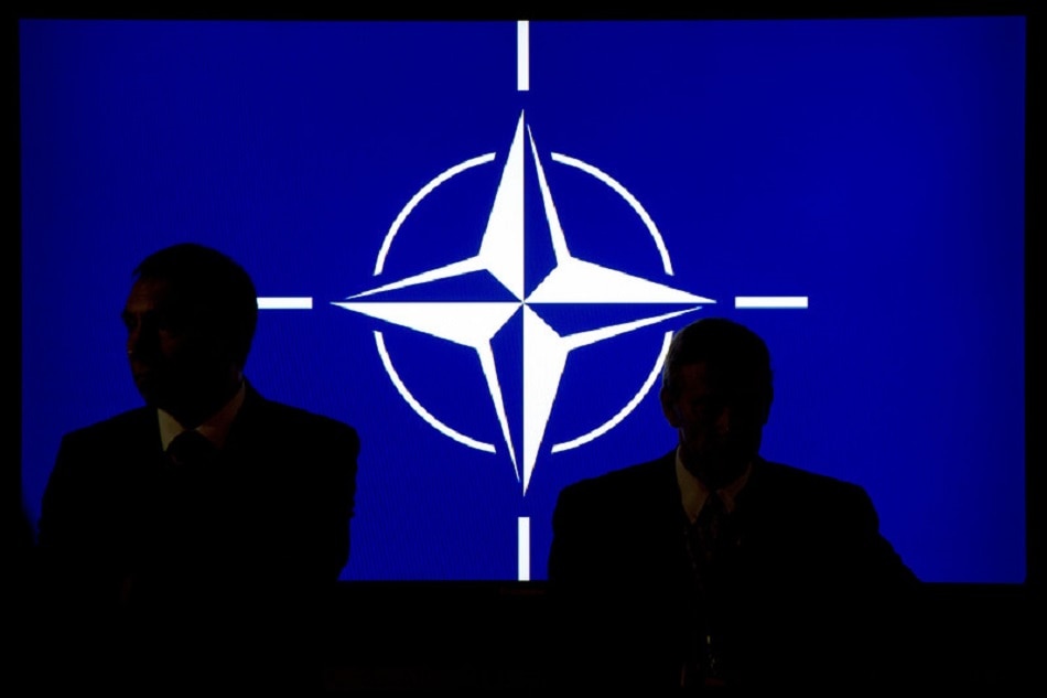 Participants sit in front of the NATO logo during the NATO summit in Newport, South Wales, September 4, 2014. Maurizio Gambarni, EPA/file