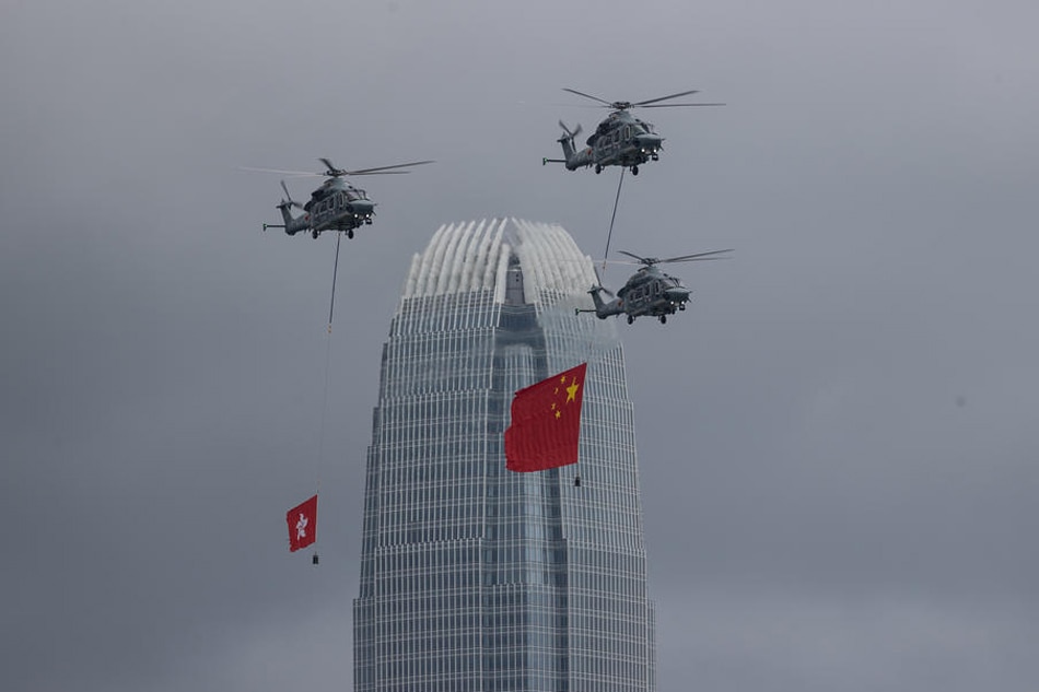 Government Flying Services aircrafts display the People’s Republic of China and the Hong Kong SAR flags over the Convention Center in Hong Kong, China, July 1, 2022. Chinese President Xi Jinping is visiting the city to mark the 25th Anniversary of the establishment of the Hong Kong Special Administrative Region (HKSAR) of the People’s Republic of China.  Jerome Favre, EPA-EFE