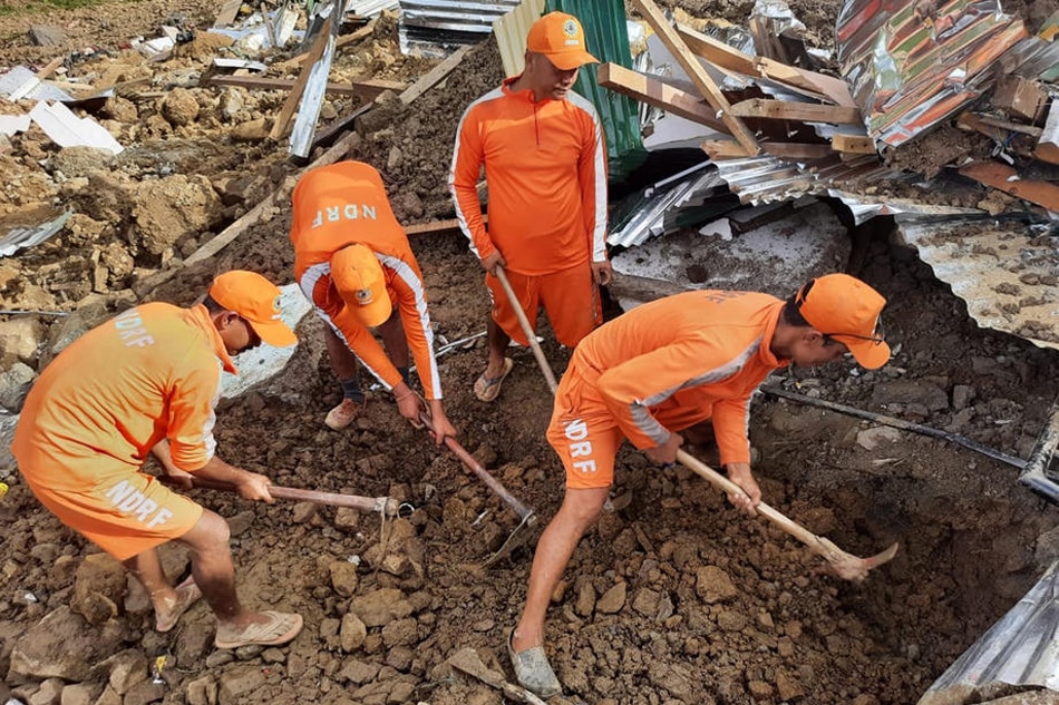 A handout photo made available by India's National Disaster Response Force (NDRF) shows NDRF personnel during rescue operation in Noney district of Manipur, India on June 30, 2022. EPA-EFE/National Disaster Response Force handout 