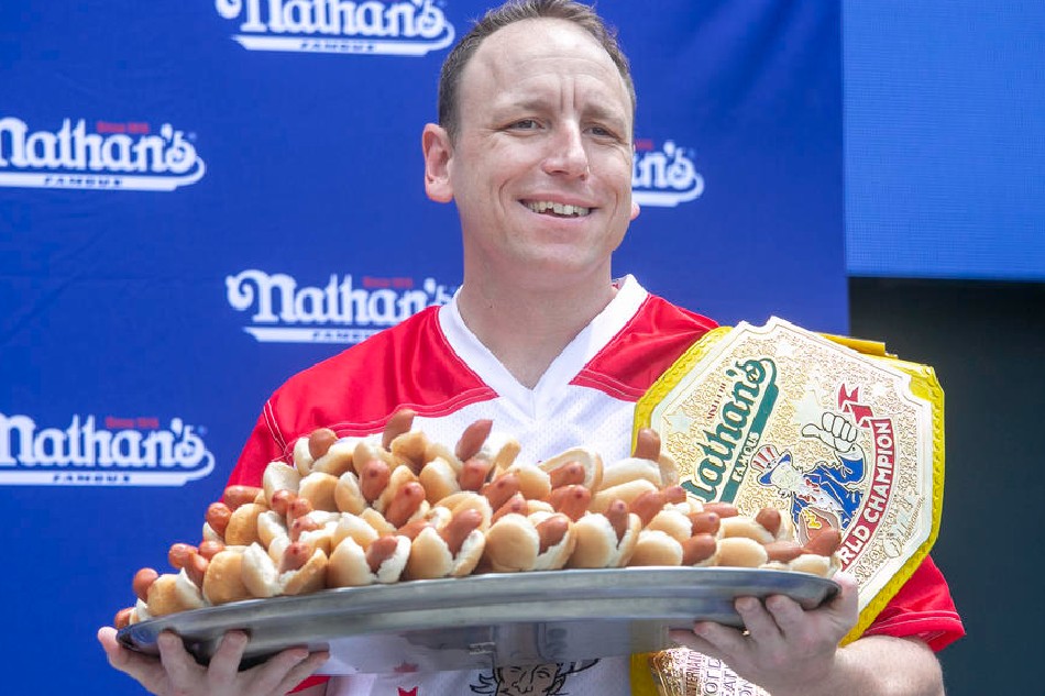 Joey Chestnut poses with a plate with the amount of hot dogs and buns he ate during last year's competition, during a weigh-in ceremony for Nathan's Famous Fourth of July International Hot Dog Eating Contest, New York, July 1, 2022. Sarah Yenesel, EPA-EFE