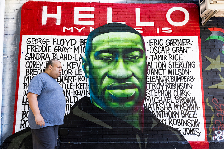 A person walks past a mural for George Floyd on the one year anniversary of his murder in the Brooklyn borough of New York, New York, USA, 25 May 2021. Floyd was killed in Minneapolis, Minnesota, after now-convicted former police officer Derek Chauvin kneeled on Floyd