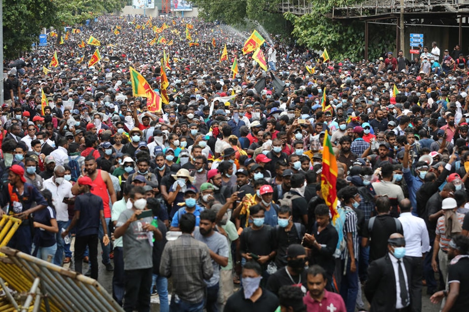 People attend a protest rally, calling for the resignation of the president over the alleged failure to address the economic crisis, near the President's house in Colombo, Sri Lanka, on July 9, 2022. Chamila Karunarathne, EPA-EFE 