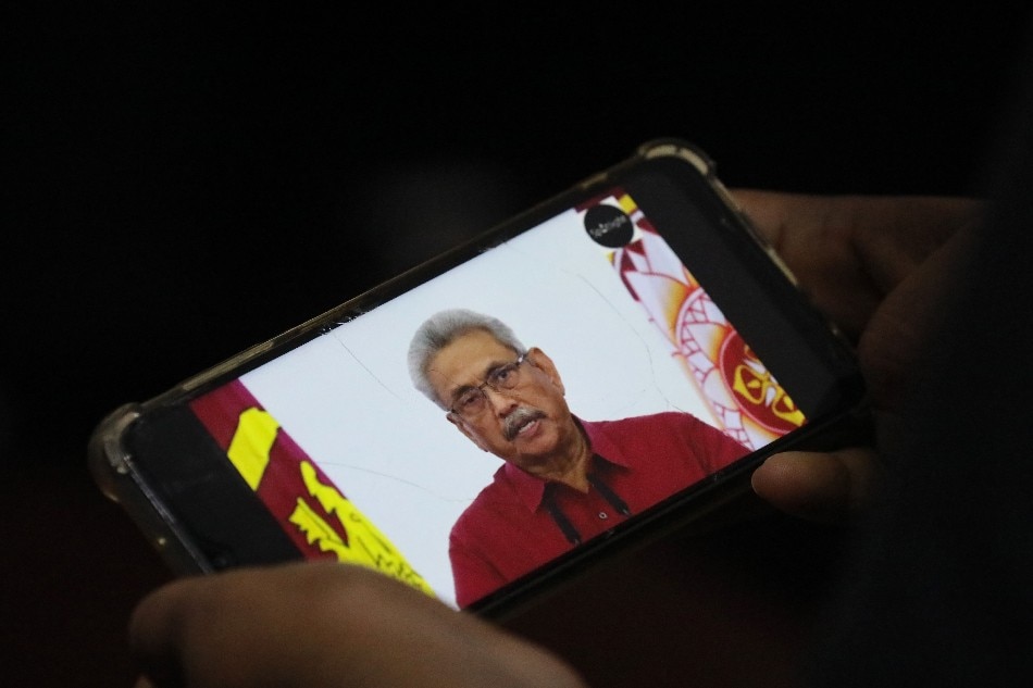 A person watches a video on a mobile phone of Sri Lanka President Gotabaya Rajapaksa addressing the nation on television, in Colombo, Sri Lanka, 11 May 2022 (reissued 09 July 2022). Sri Lankan President Rajapaksa on 09 July 2022 has agreed to resign on 13 July, the parliament's speaker said in a statement after a party leaders' meeting. Thousands of protesters broke through police barricades and stormed the president's official residence during anti-government protest in Colombo. Violent protests have been rocking the country for months over the government's alleged failure to address the worst economic crisis in decades. EPA-EFE/CHAMILA KARUNARATHNE