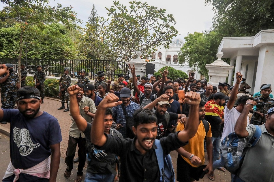 Protesters cheer and shout slogans after they vacate the Prime Minister's office in Colombo, Sri Lanka, 14 July 2022. after the resignation of Gotabaya Rajapaksa from the presidency was sent to the parliament speaker. Thousands of protesters broke through police barricades and stormed in to the President Palace, President office, Prime Minister's Residency and Prime Minister's office on 09 July. Meanwhile, Sri Lankan authorities declared a state of emergency and imposed a curfew in the Western Province of the country on 13 July. Sri Lankan President Gotabaya Rajapaksa has authorized the prime minister Prime Minister Ranil Wickremesinghe to carry out presidential duties after the president fled to the Maldives amid months of protests against the economic crisis. EPA-EFE/CHAMILA KARUNARATHNE