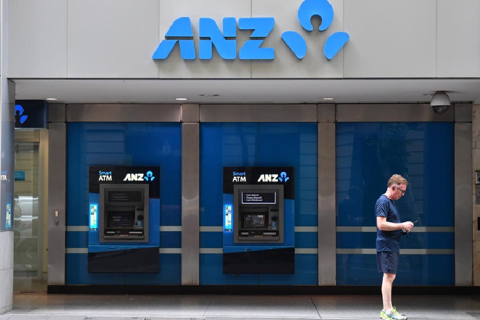 A man stands near Australia and New Zealand Banking Group Limited (ANZ) automatic teller machines (ATMs) in Sydney, New South Wales, Australia, Dec. 16, 2019. Mick Tsikas, EPA-EFE/File 