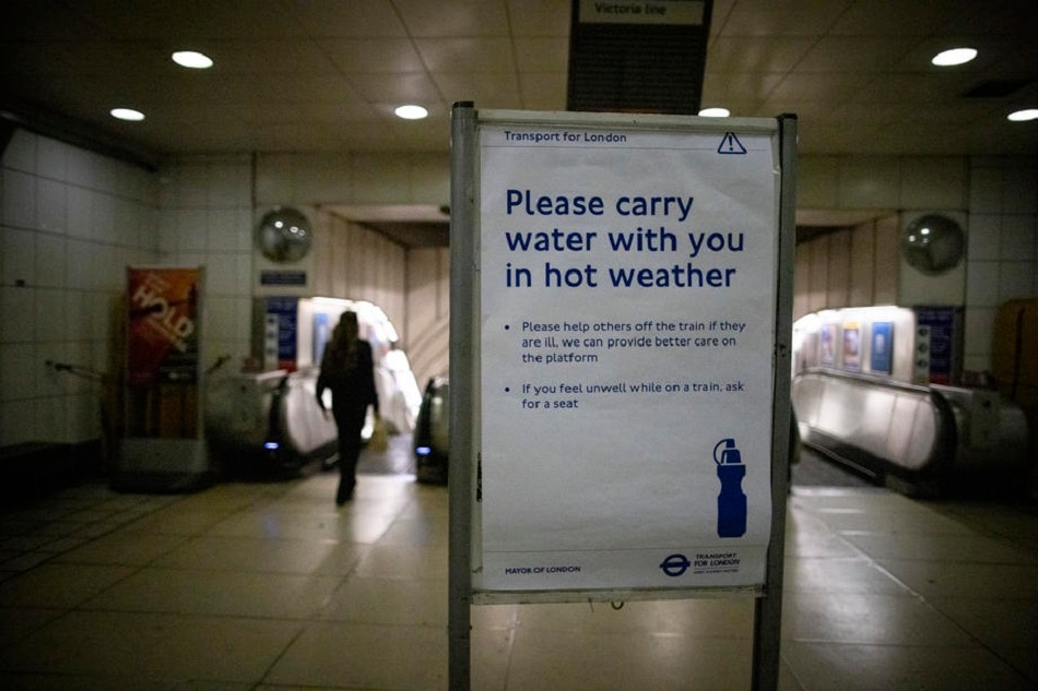 A sign advises people to carry water with them on London Underground, due to the hot weather, in London, July 19, 2022. Britain is suffering from extreme hot weather as the temperatures in London reached 40.2 Celsius, the highest ever on record, according to Met Office figures. Tolga Akmen, EPA-EFE