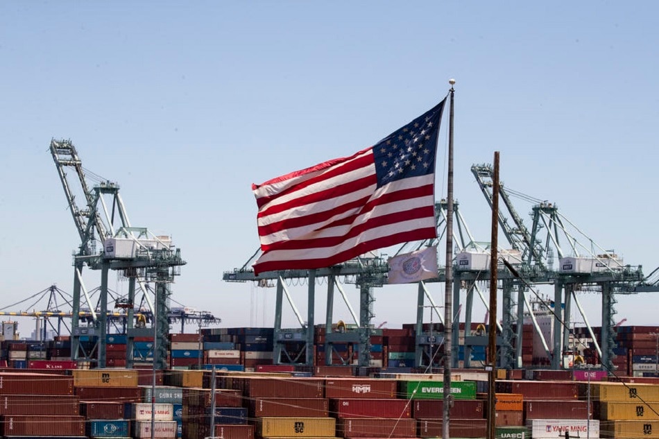 The US flag towers above hundreds of containers the Port of Los Angeles, July 7, 2022. Etienne Laurent, EPA-EFE