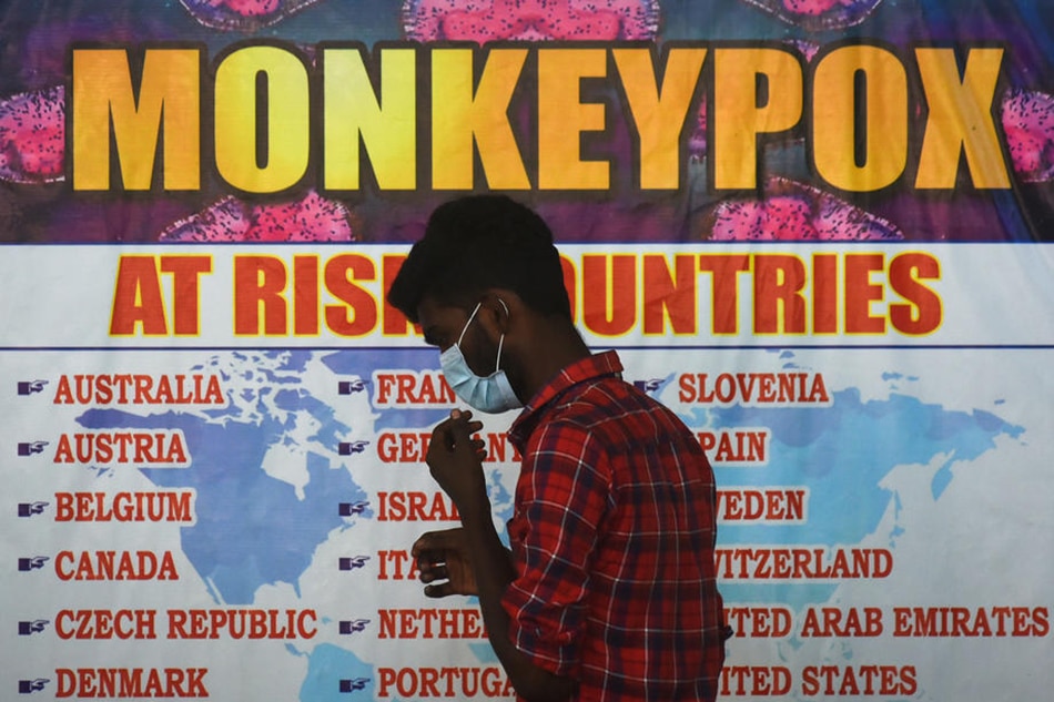 An Indian health worker walks in front of a list of high-risk countries for the Monkeypox virus, as India reported the first case of Monkeypox in the WHO South-East Asia Region, at Chennai International Airport, in Chennai, India, July 16, 2022. Idrees Mohammed, EPA-EFE 
