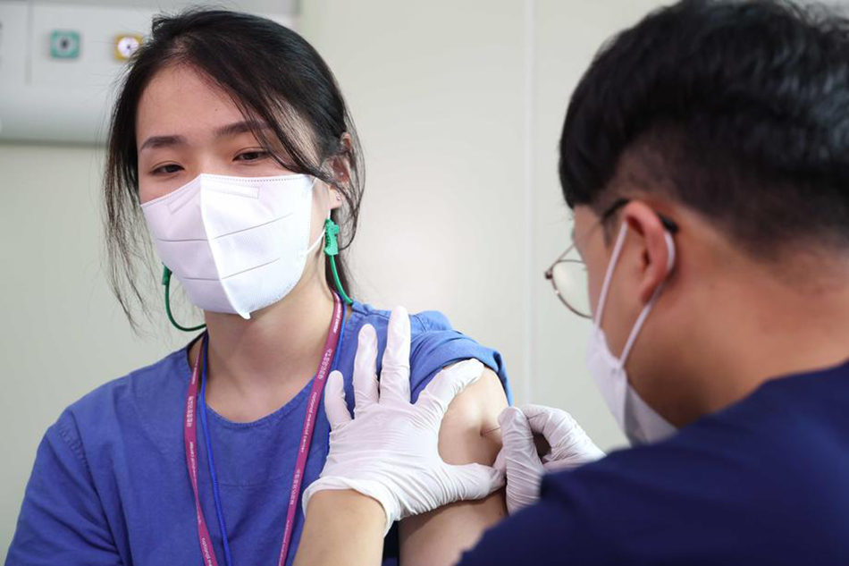 A medical worker gets a vaccine against monkeypox from her colleague at the National Medical Center in Seoul, South Korea, June 27, 2022, as such vaccination for medical workers began in the country. EPA-EFE/Yonhap