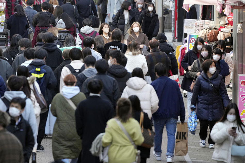 Pedestrians wearing protective face masks crowd a street in Tokyo, Japan, on February 3, 2022. Franck Robichon, EPA-EFE/file 