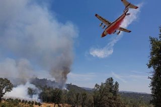 US heat wave soars as California wildfire rages