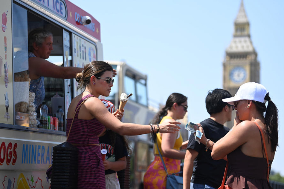 A woman buys ice cream in London, July 19, 2022. The Met Office issued a red extreme heat warning as the UK could have its hottest day on record that week, with temperatures forecast to hit up to 41C. Neil Hall, EPA-EFE