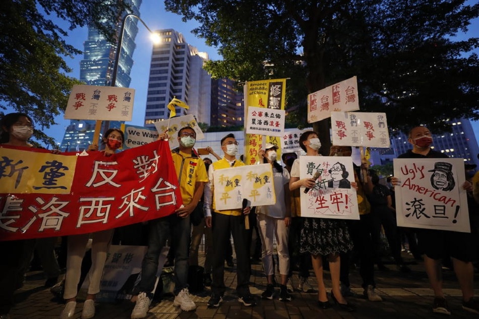 Taiwanese hold placards during a protest against the visit of US House Speaker Nancy Pelosi, in Taipei, Taiwan, August 2, 2022. China has raised a warning stating its military will not sit idle if Pelosi visits Taiwan. Ritchie B. Tongo, EPA-EFE