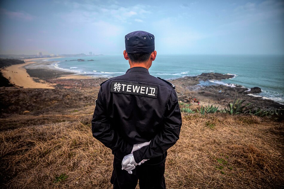 A security guard watches the coastal line, which faces Taiwan, near Xiamen city, Fujian Province, China, March 2, 2019. Aleksandar Plavevski, EPA-EFE