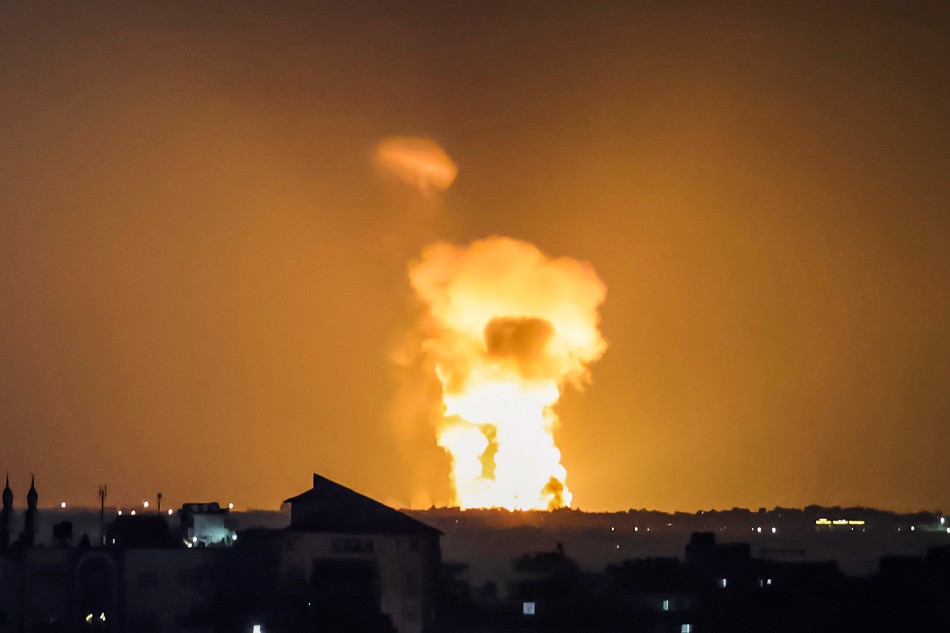 A fireball rises from the site of an Israeli airstrike in Khan Yunis in the southern Gaza Strip on August 7, 2022 shortly before a ceasefire. Israel's army said it was striking 'a wide range' of Palestinian militant targets in Gaza after a 2030 GMT ceasefire came into force, responding to rocket fire moments earlier. MOHAMMED ABED / AFP