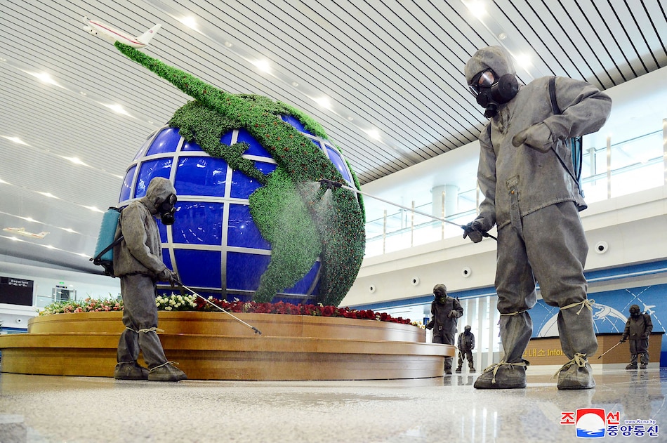 This picture taken on June 10, 2022 and released from North Korea's official Korean Central News Agency (KCNA) on June 11 shows workers disinfecting the interior of Pyongyang International Airport as part of measures against COVID-19. KCNA via KNS/AFP