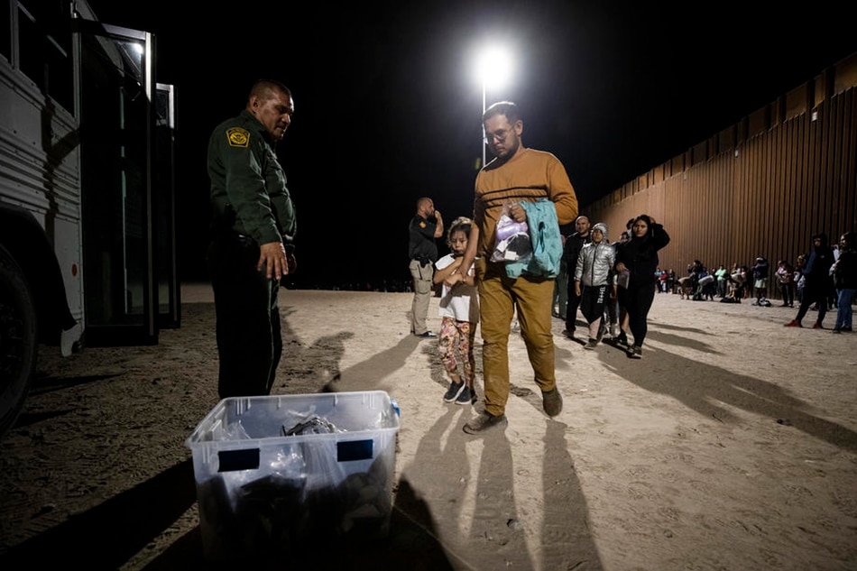Migrants leave their saved precious items in a box before boarding a bus to a processing center as hundreds cross the border between Mexico and the US in Yuma, Arizona, USA, June 21, 2022. Coming from all over the world, most of the migrants who cross the border where the wall ends at the limit of the Cocopah Indian Reservation, willingly turn themselves to US Border Patrol officers who will process them as they ask for asylum. Etienne Laurent, EPA-EFE/File 
