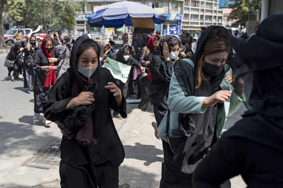 Taliban fighters fire in air to disperse Afghan women protesters in Kabul on August 13, 2022. Wakil Kohsar, AFP