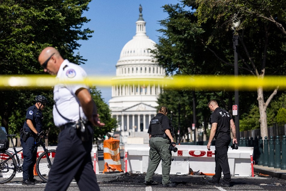 US Capitol police inspect where a burning car crashed into a US Capitol barricade in Washington, DC, USA, 14 August 2022. The driver of the vehicle reportedly fired a weapon at Capitol police before shooting himself. EPA-EFE/JIM LO SCALZO