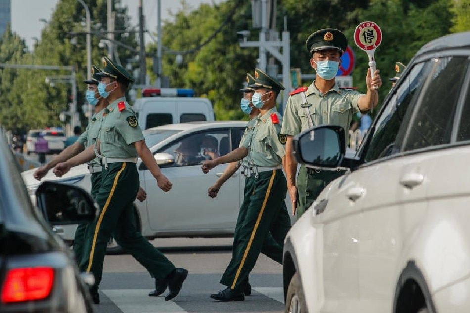 Soldiers cross a road outside the US Embassy in Beijing, China, Aug. 3, 2022. Mark R. Cristino, EPA-EFE