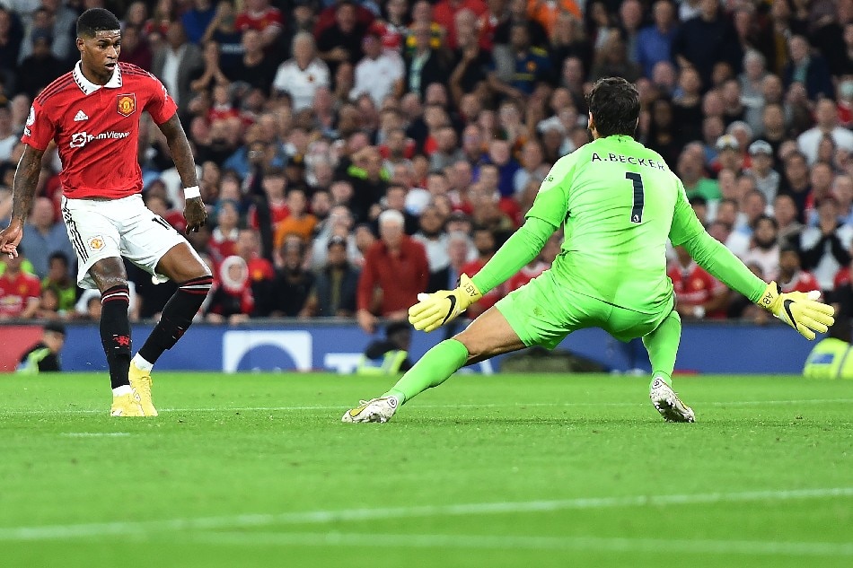 Marcus Rashford of Manchester United (L) scores past goalkeeper Allison of Liverpool during the English Premier League soccer match between Manchester United and Liverpool FC in Manchester, Britain, 22 August 2022. Peter Powell, EPA-EFE