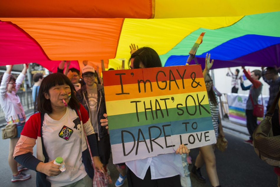 Demonstrators walk under a giant rainbow flag and chant slogans during a gay pride parade, in Hong Kong, China, 10 November, 2012. The demonstrators took to the streets calling to end work-place discrimination and for the legalization of gay marriage. Jerome Favre, EPA/File 