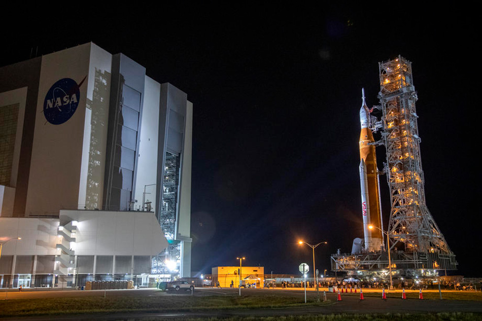 The SLS rocket with an Orion capsule, part of the Artemis 1 mission, is being transported from the NASA’s Vehicle Assembly Building to pad 39B at Kennedy Space Center in Merrit Island, Florida, USA, Aug. 16, 2022. The Artemis 1 mission is an uncrewed test flight of the Orion spacecraft and the first launch of the SLS. The Artemis is an ongoing space mission run by NASA with the goal of landing the first female astronaut and first astronaut of color on the Moon. It is the US space agency