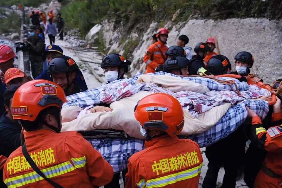 This photo taken on Sept. 5, 2022 shows rescue workers carrying an injured person after a 6.6-magnitude earthquake in Luding county, Ganzi, in China's southwestern Sichuan province. Photo by CNS/AFP 