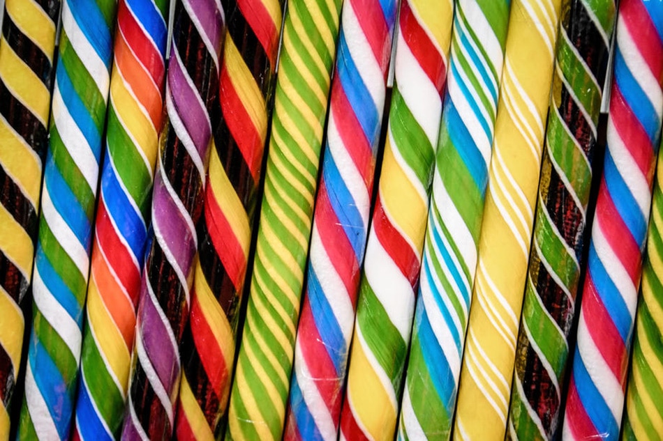 Colorful candy sticks are shown at a sweets trade fair in Cologne, Germany, January 31, 2022. Sascha Steinbach, EPA-EFE/file