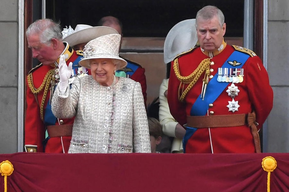 Queen Elizabeth II and Prince Andrew stand on the balcony of Buckingham Palace with other members of the Royal Family to watch a fly-past during the Trooping of the Colour Queen's birthday parade, in London, June 8, 2019. Neil Hall, EPA-EFE/file