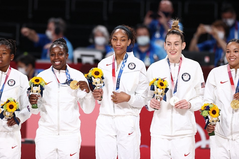 Chelsea Gray #8, A'ja Wilson #9, Breanna Stewart #10, and Napheesa Collier #11 of the USA Women's National Team celebrate after winning the Gold Medal Game of the 2020 Tokyo Olympics at the Super Saitama Arena on August 8, 2021 in Tokyo, Japan. Stephen Gosling, NBAE via Getty Images/AFP