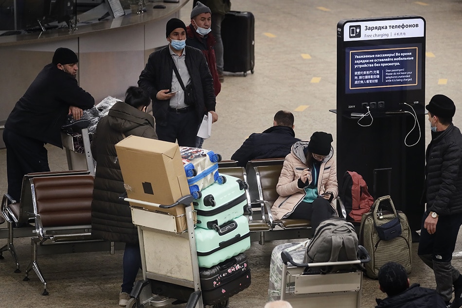 Passengers wearing protective face masks rest with their luggage at the Terminal D of the Sheremetyevo International Airport, during the pandemic of SARS-CoV-2 coronavirus in Moscow, Russia, 16 January 2021. EPA-EFE/MAXIM SHIPENKOV